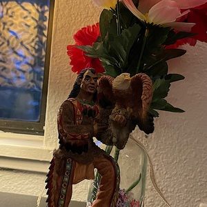 Statue of a Native American holding a bald eagle